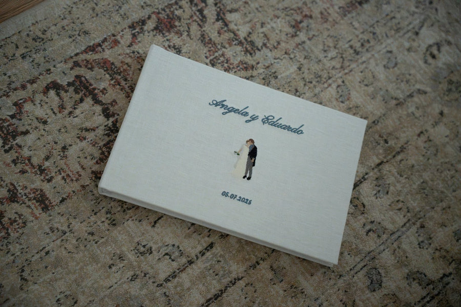 Álbum de boda de lino natural cerrado, con los nombres y la fecha bordados a mano en la tapa